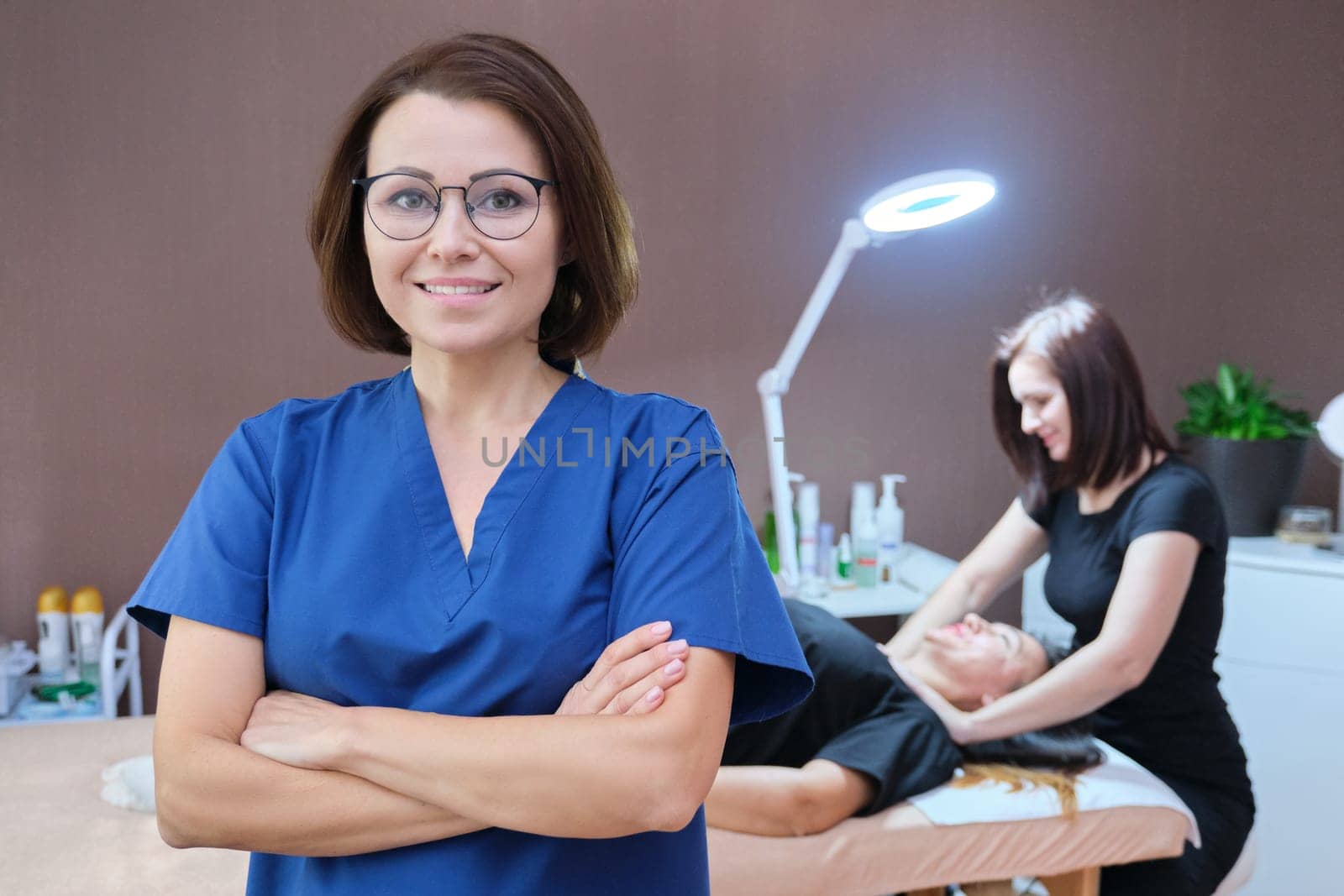 Portrait of woman cosmetologist doctor with crossed arms at beauty clinic. People, spa, cosmetology and skincare concept