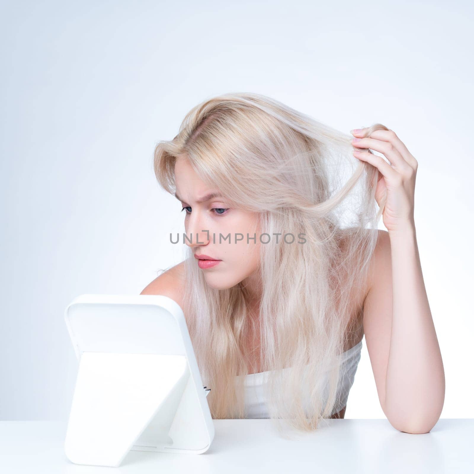Personable beauty fresh clean skin woman having dry hair problem. Frustrated facial expression concept of damaged hair loss for shampoo ads in copyspace isolated background.