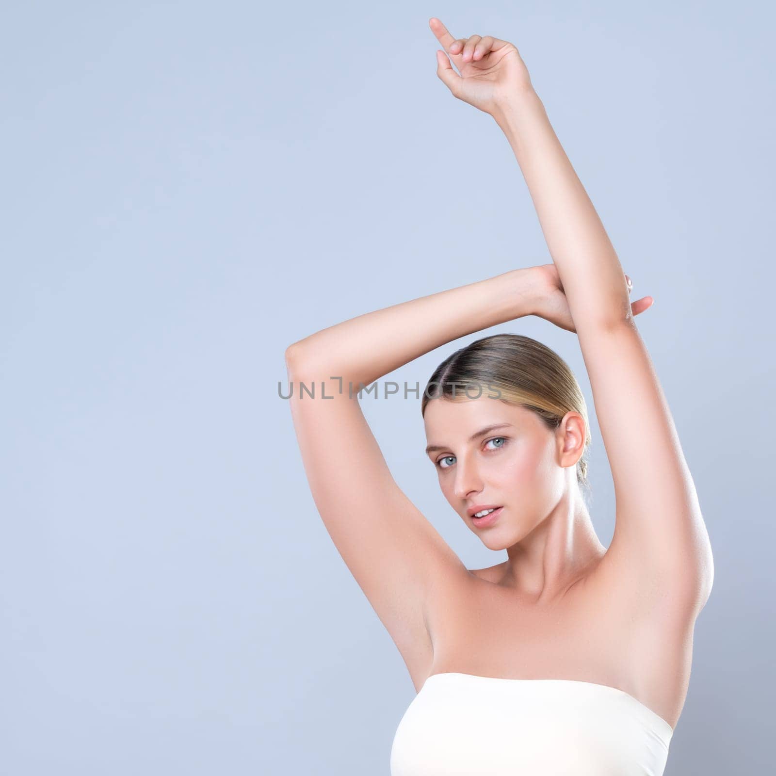 Alluring beautiful woman with perfect smooth and clean skin portrait in isolated background. Beauty hand gesture with expressive facial expression for skincare treatment product or spa.