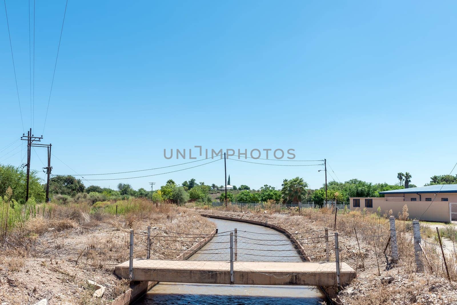 Pedestrian bridge over a canal in Groblershoop by dpreezg