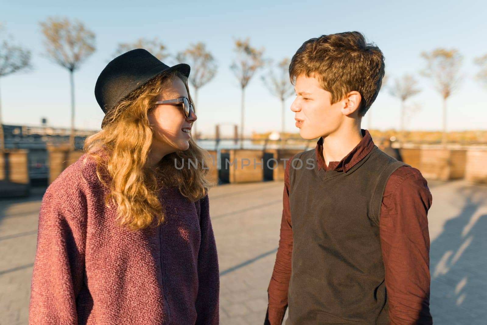 Outdoor portrait of a couple of young teenagers boy and girls by VH-studio