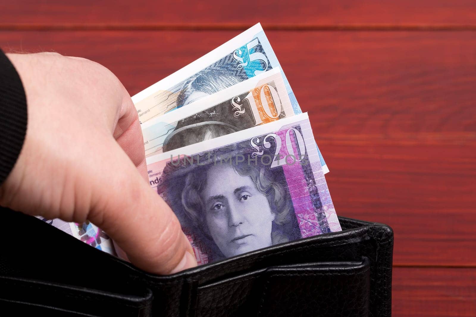 Scottish money - Pound in the black wallet by johan10