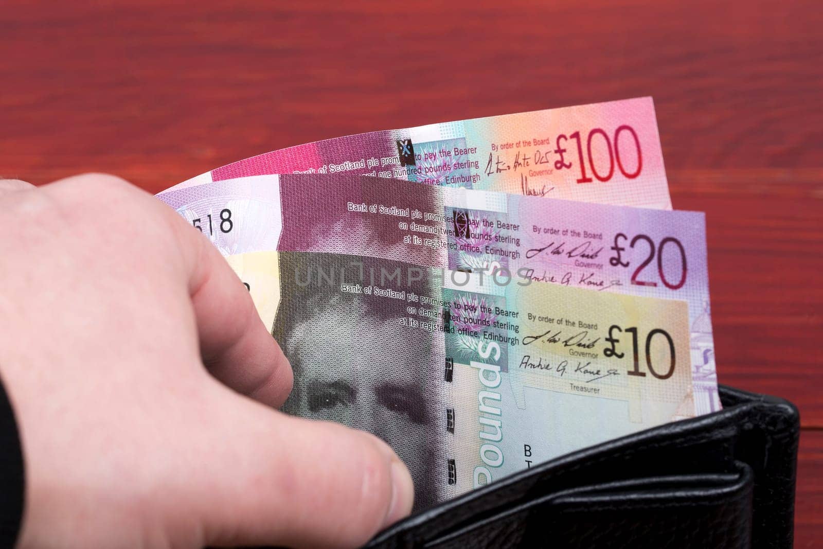 Scottish money - Pound in the black wallet by johan10