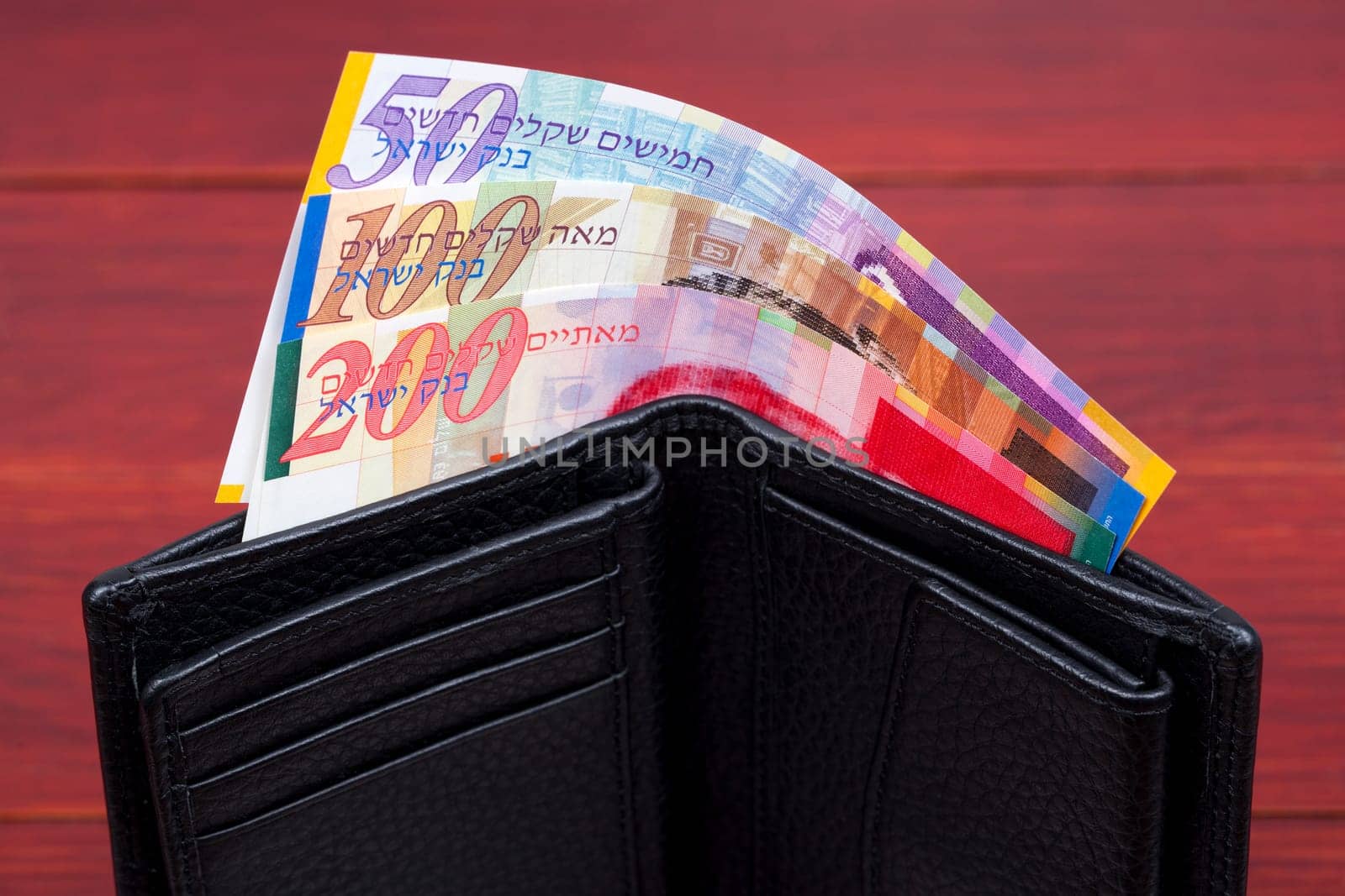 Banknotes from Israel in a black wallet