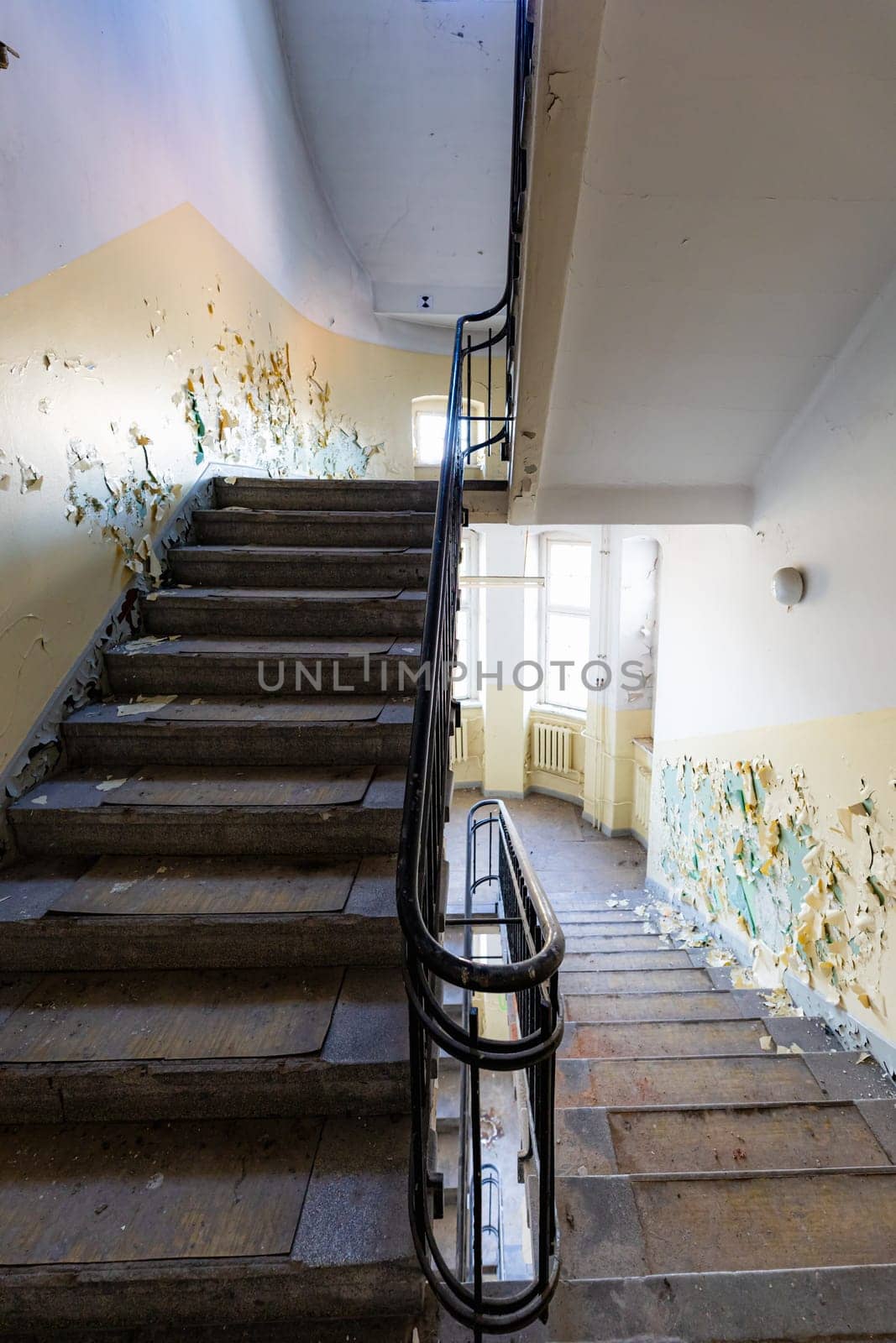 View of an old rectangular spiral staircase in an old abandoned building by Wierzchu