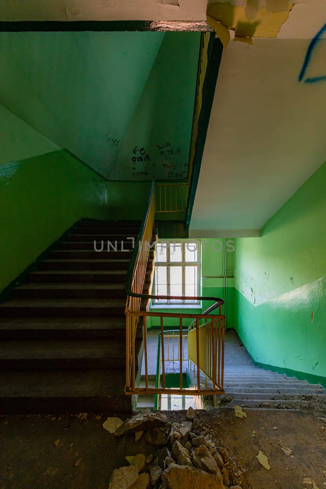 View of an old rectangular spiral staircase in an old abandoned building by Wierzchu