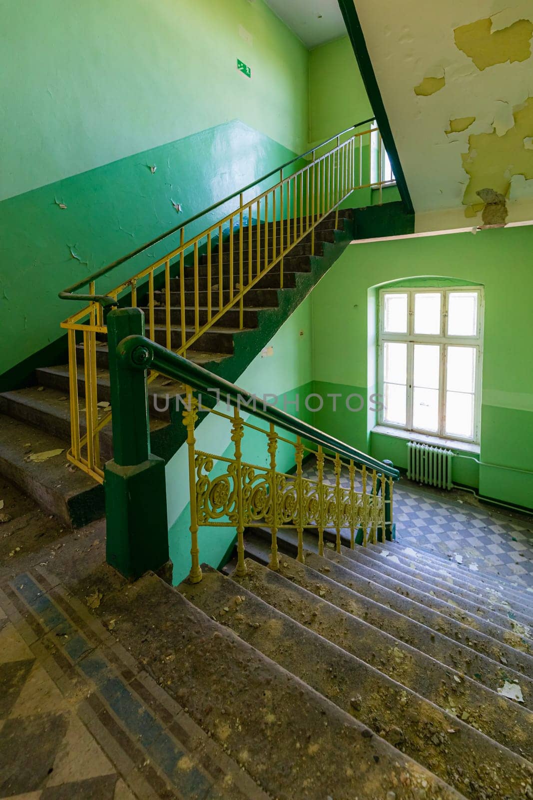 View of an old rectangular spiral staircase in an old abandoned building by Wierzchu