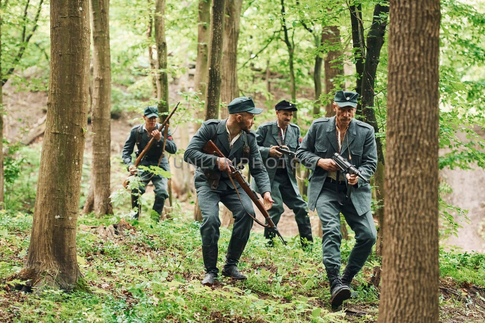 TERNOPIL, UKRAINE - June 2020 UPA Ukrainian Insurgent Army movie filming. Pictures of backstage. Young and old soldiers with weapons is attacking.