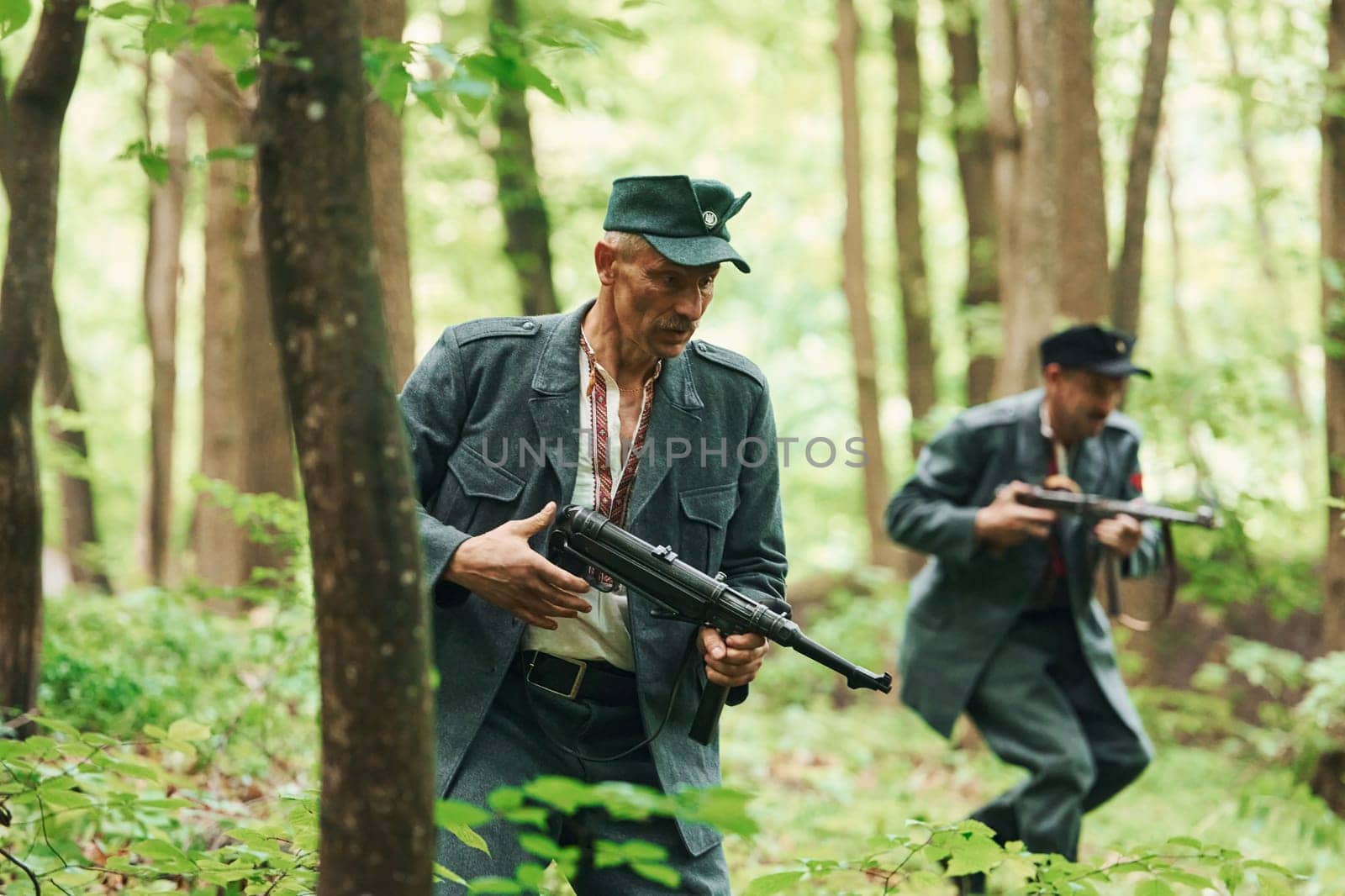 TERNOPIL, UKRAINE - June 2020 UPA Ukrainian Insurgent Army movie filming. Pictures of backstage. Young and old soldiers with weapons is attacking.