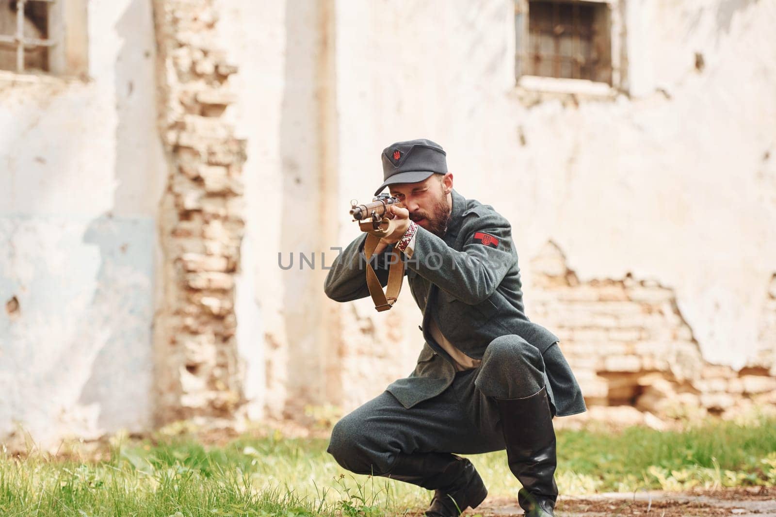 TERNOPIL, UKRAINE - June 2020 UPA Ukrainian Insurgent Army movie filming. Pictures of backstage. Young soldier with weapon near old building.