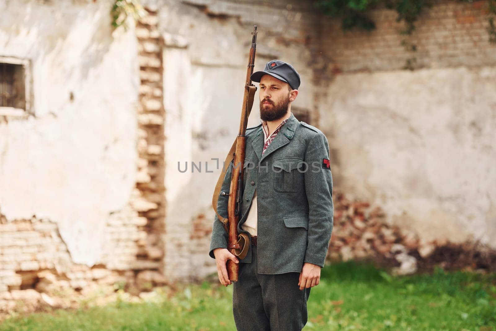 TERNOPIL, UKRAINE - June 2020 UPA Ukrainian Insurgent Army movie filming. Pictures of backstage. Young soldier with weapon near old building.