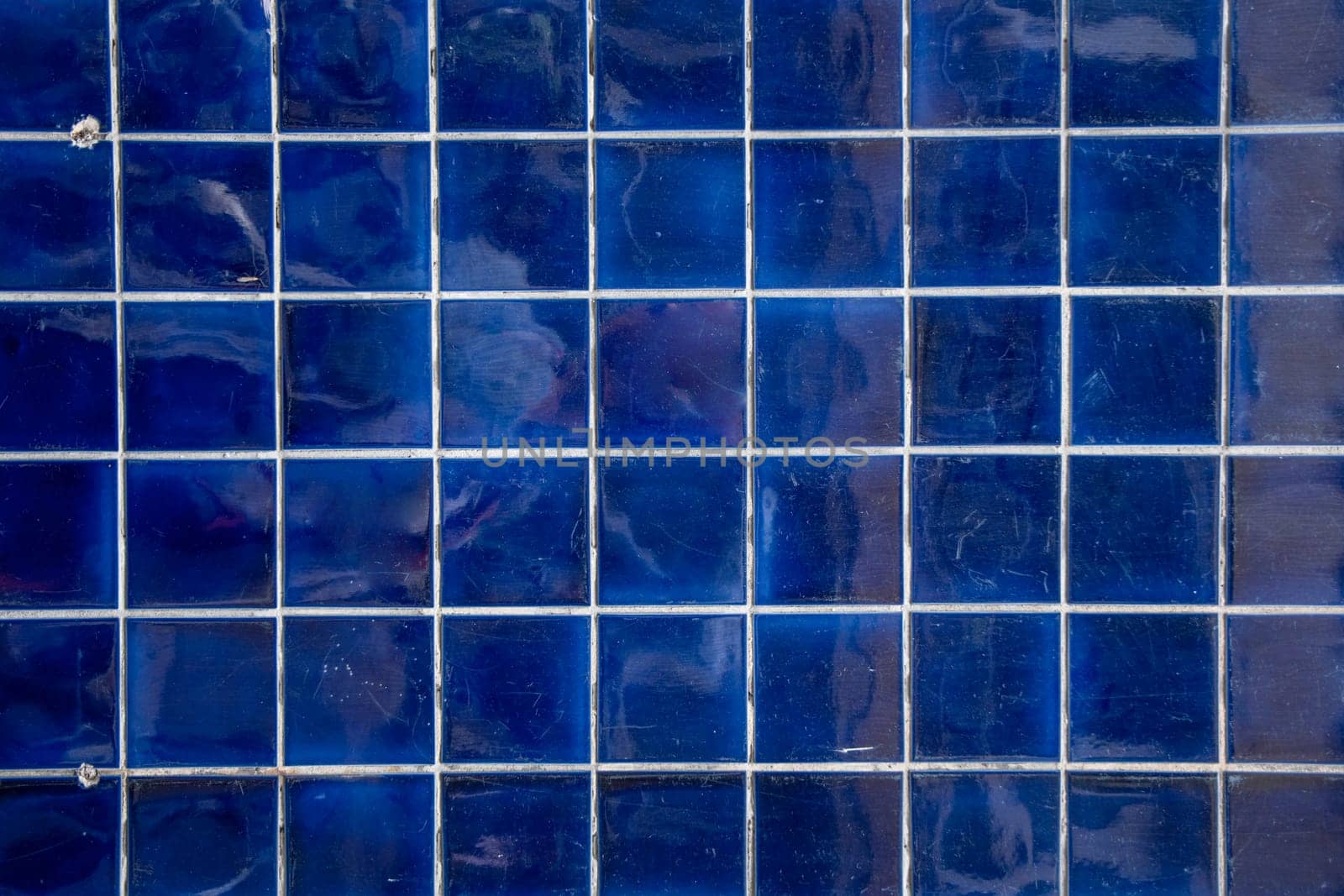 dark blue tile wall, abstract pattern mosaic background, textured wall or floor in bathroom, Space For Text. High quality photo