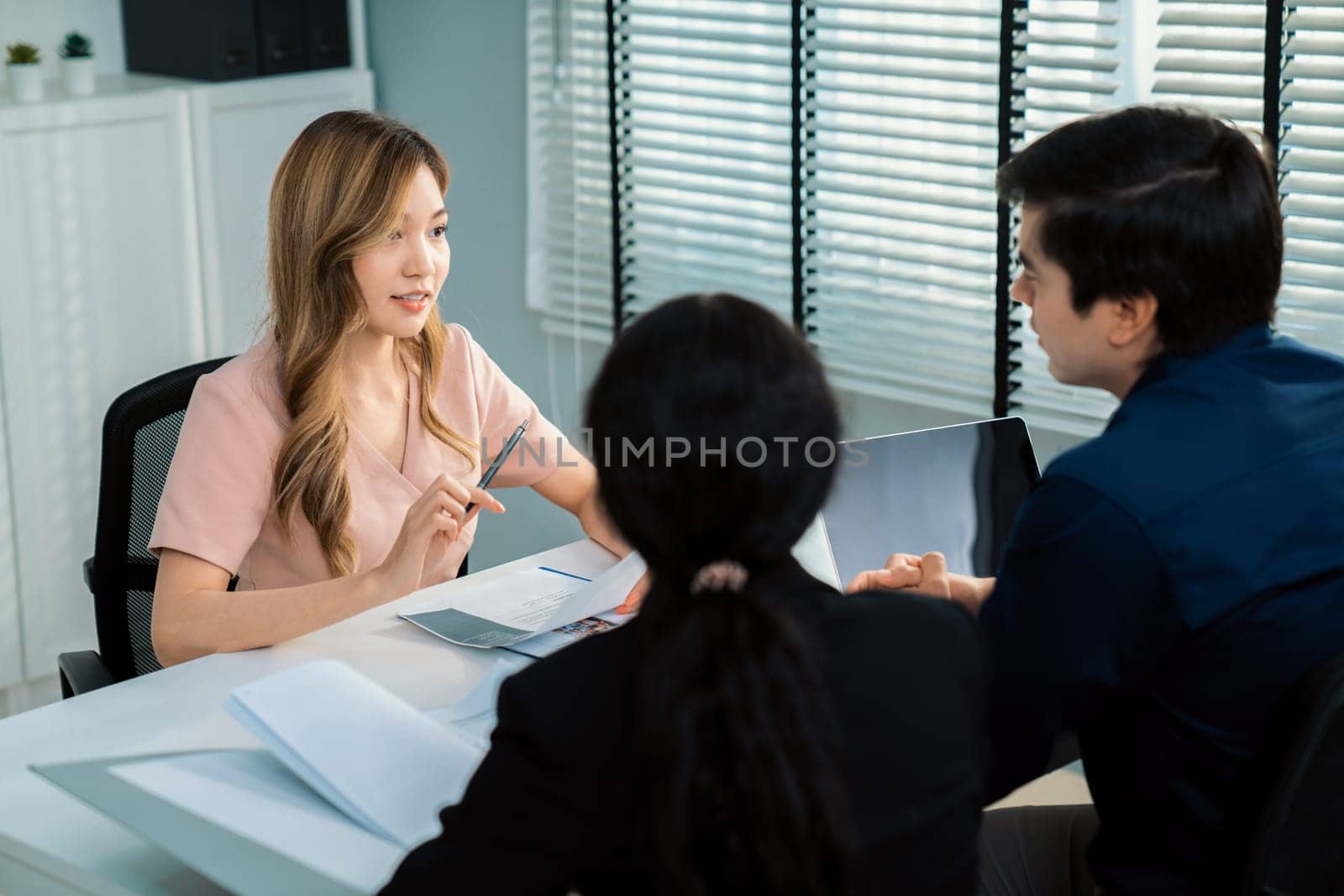 Young female asian candidate tries to impress interviewer by being competent. by biancoblue