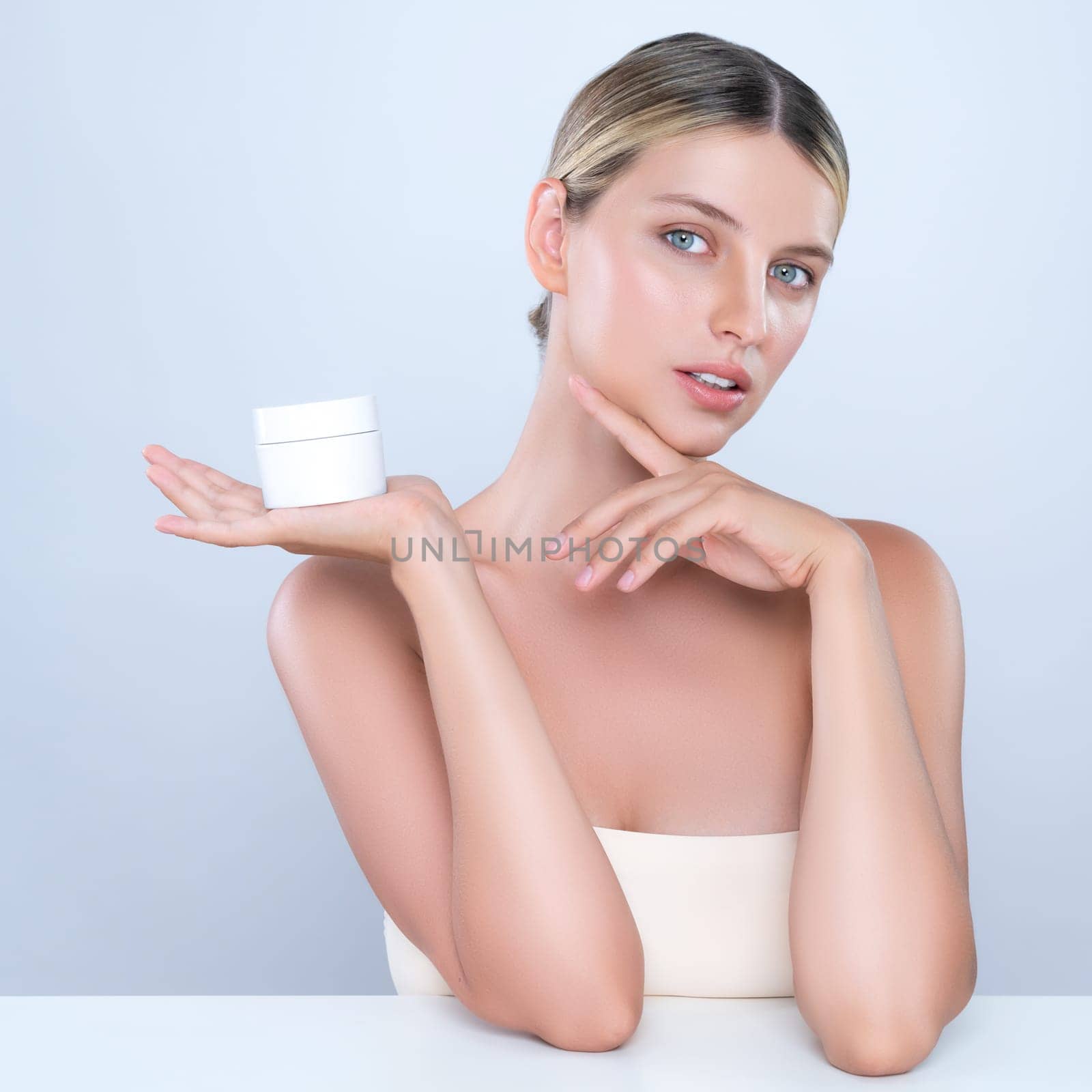 Alluring portrait of perfect skin woman holding mockup moisturizer jar. by biancoblue