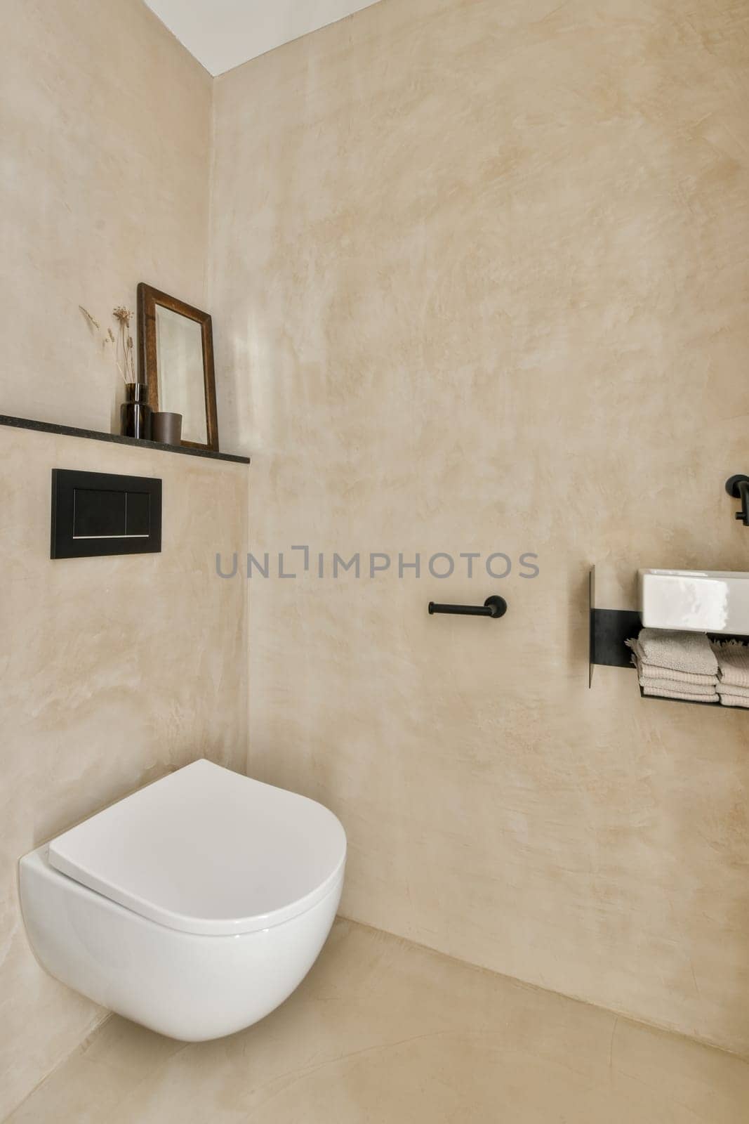 a bathroom with a toilet and a wall mounted mirror by casamedia