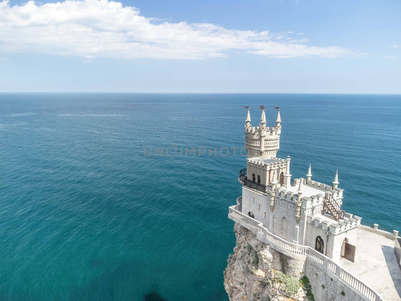 Aerial view of Swallow's Nest castle on the rock in Black Sea. It is a symbol and landmark of Crimea. Beautiful scenic panorama of the Crimea coast. Amazing Swallow's Nest at the precipice.