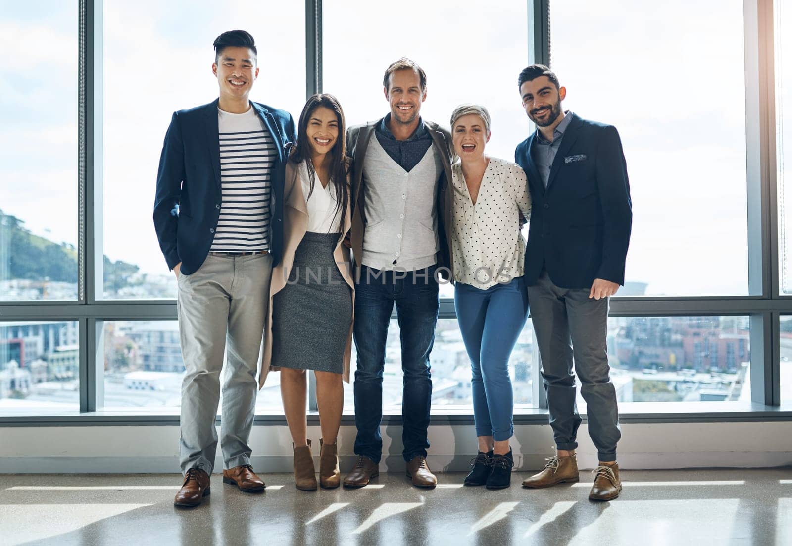 The team youll want to be part of. Portrait of a group of confident young businesspeople standing together in the office at work during the day