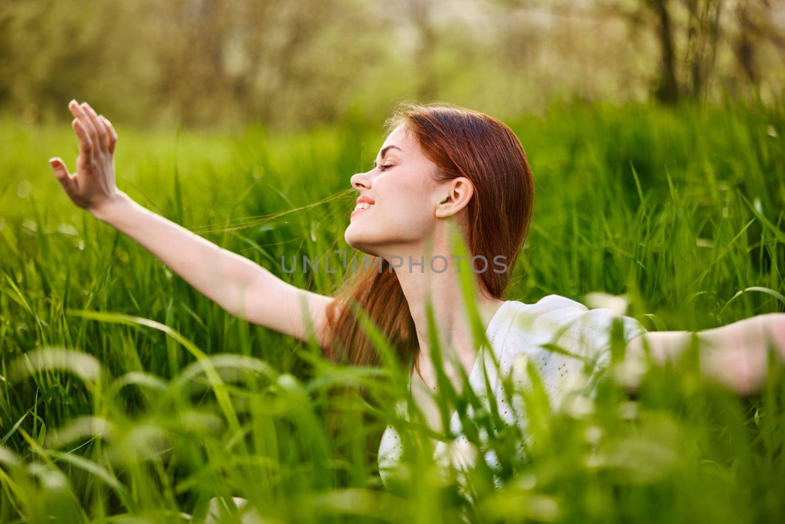 sunny summer day, a beautiful young woman lying on the grass. High quality photo