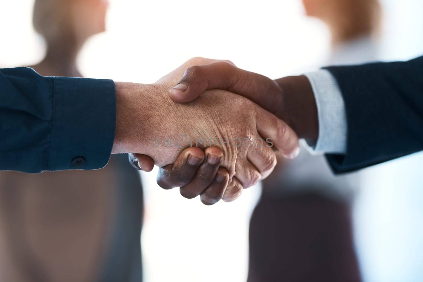 Well be great together. two unrecognizable businesspeople shaking hands in an office. by YuriArcurs