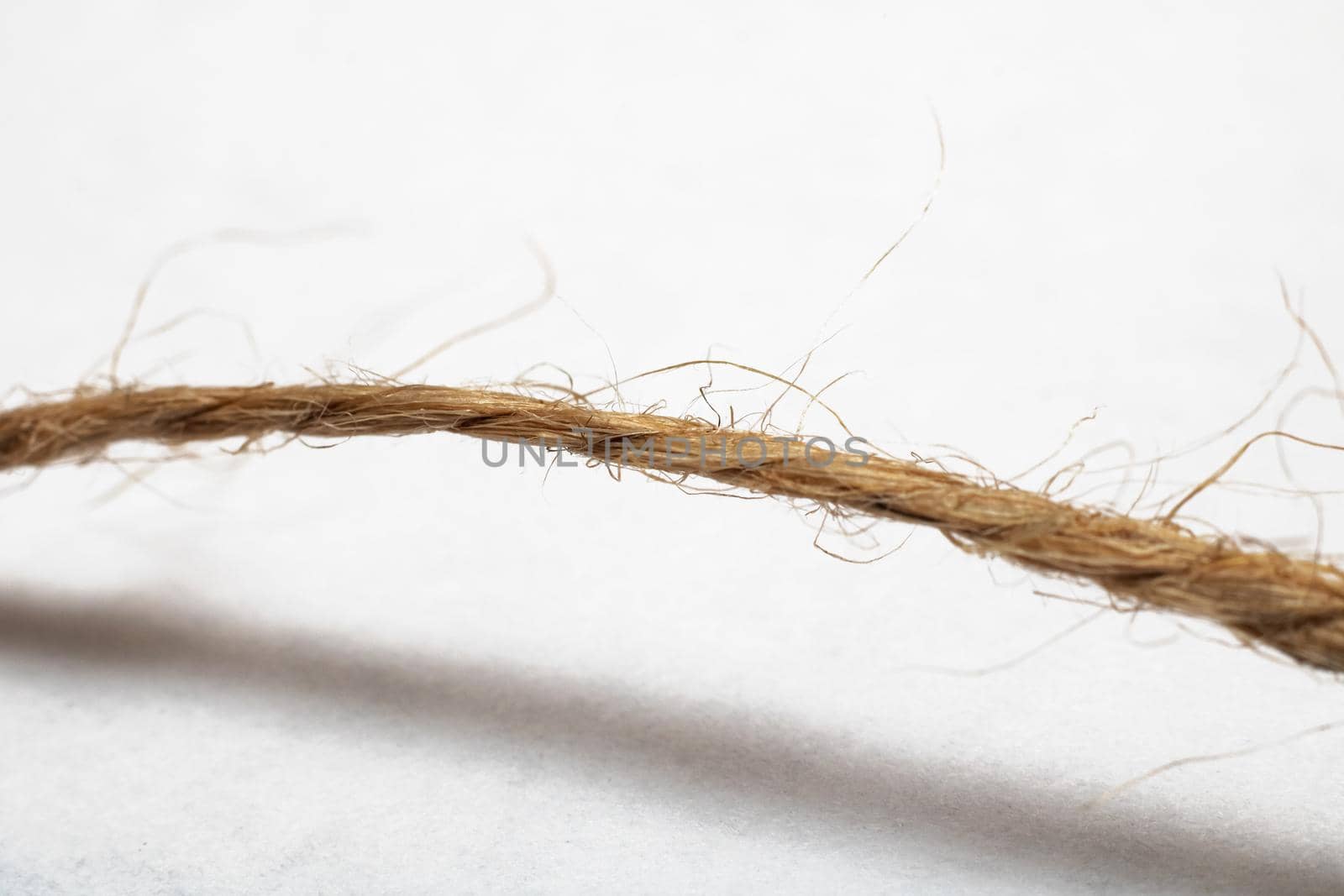 Skein of twisted yellow rope close up, isolated on white background