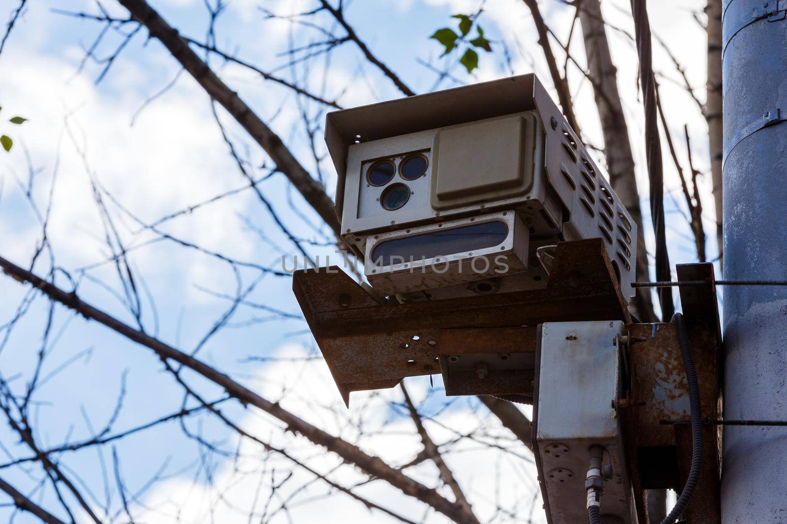 Speed radar camera detector mounted on the pole front closeup telephoto view.