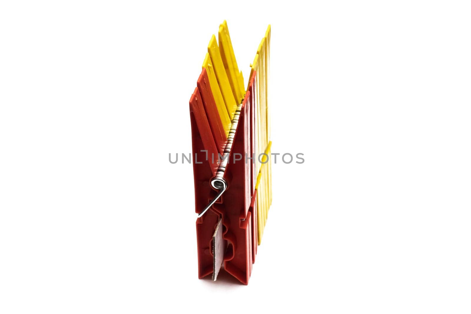 Red clothespin for drying clothes, isolated on white background