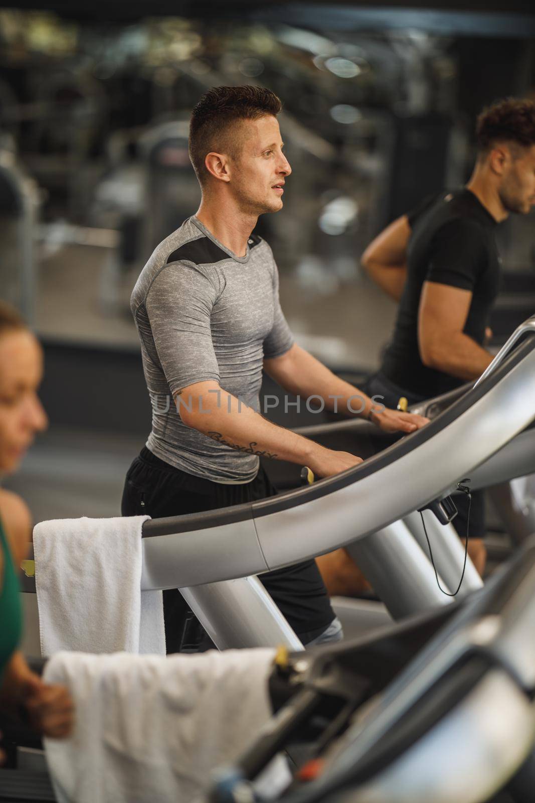 Shot of a young man exercising on a treadmill at the gym.