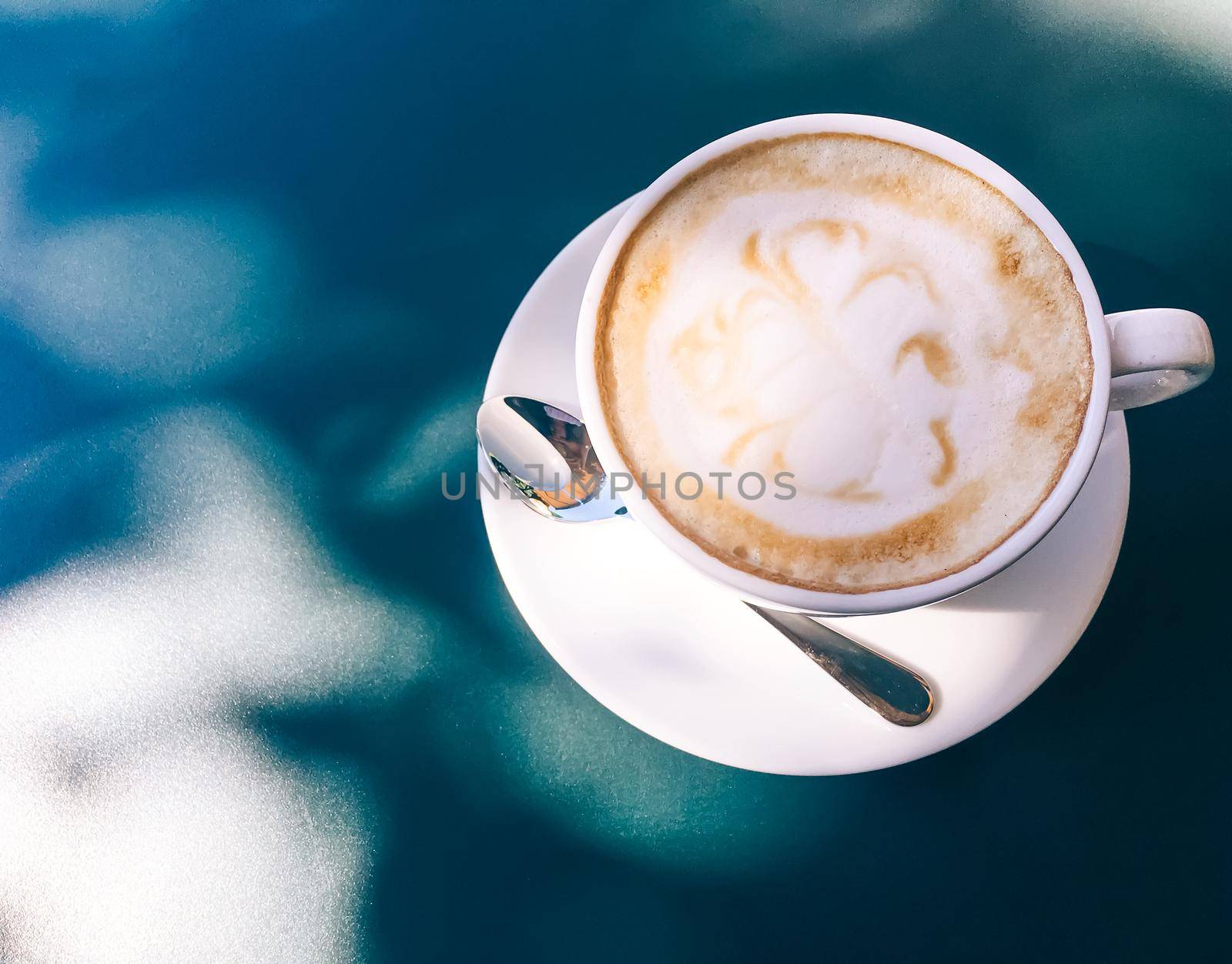Cappuccino in summer cafe outdoors by Anneleven