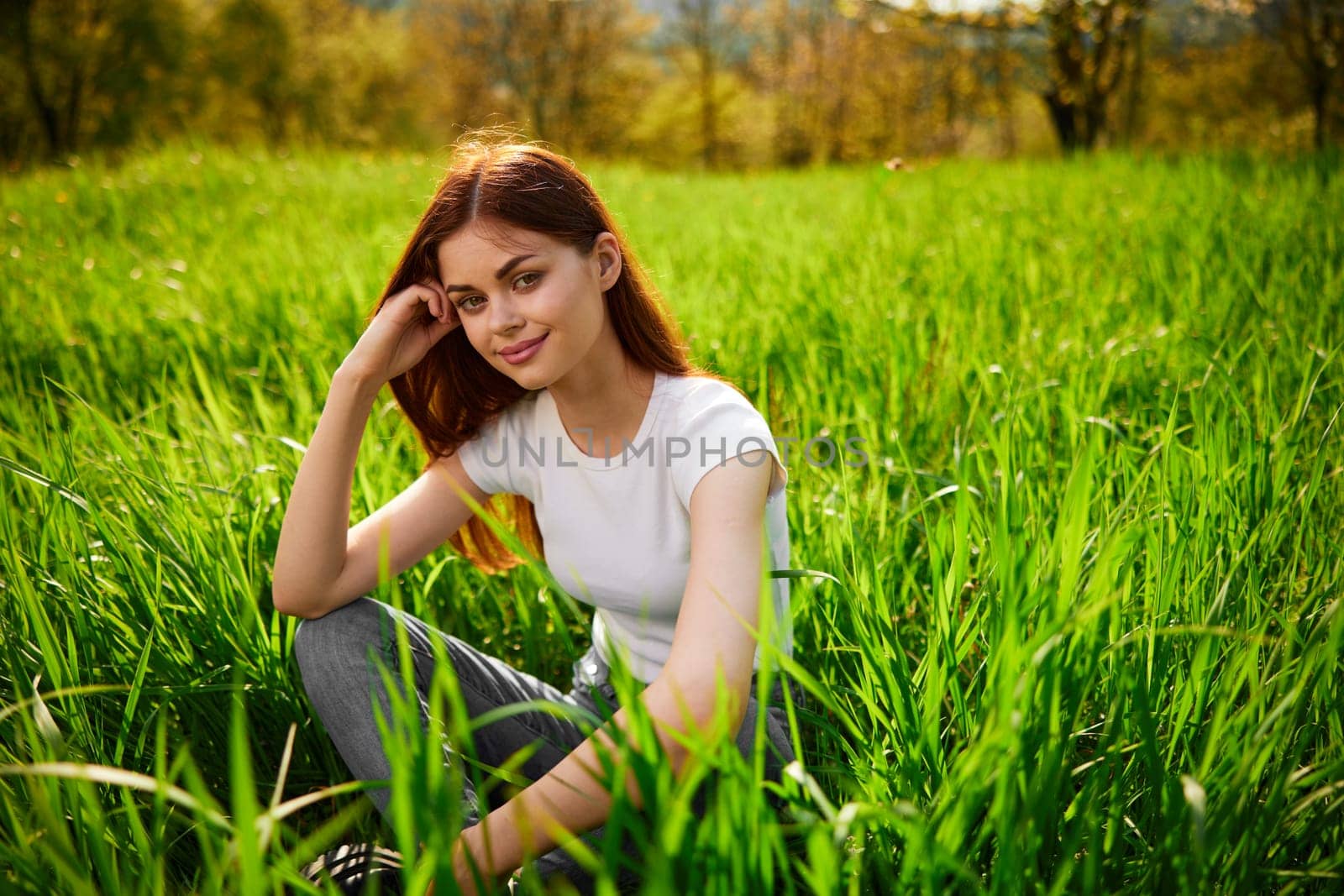 Beautiful healthy Young Woman relaxing on the green grass by Vichizh