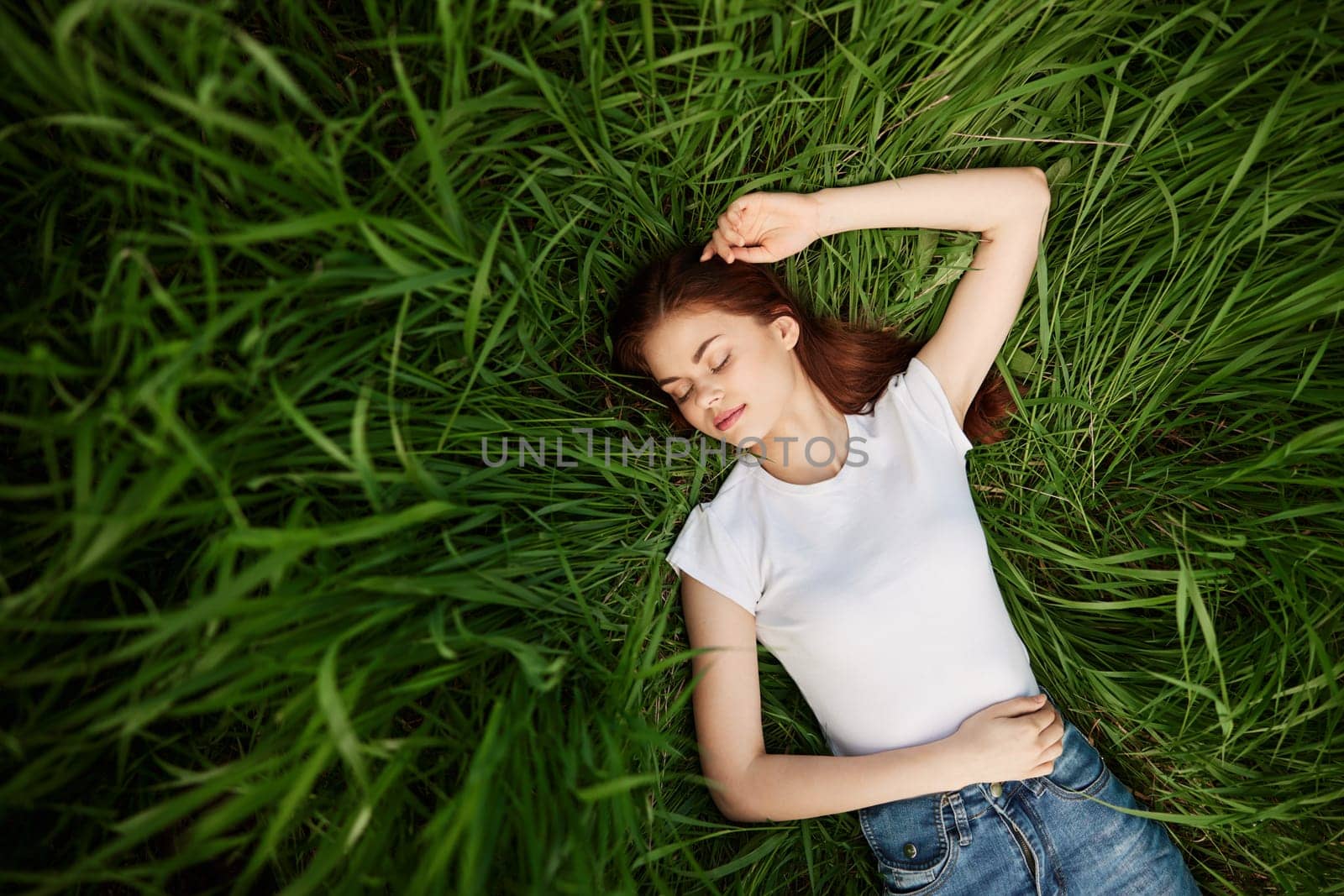 Young woman laying on meadow by Vichizh