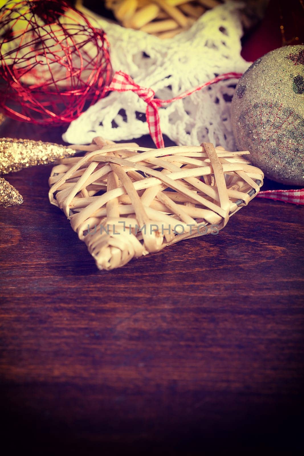Christmas heart ornaments on vintage wood background by DCStudio