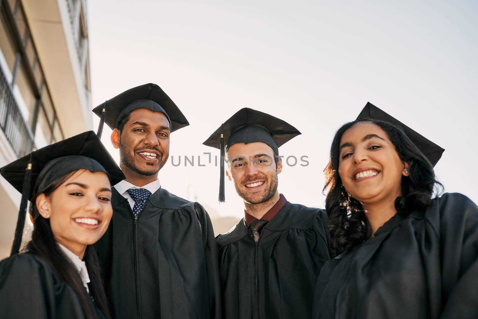 Education is a gateway into a world of opportunity. Portrait of a group of students standing together on graduation day