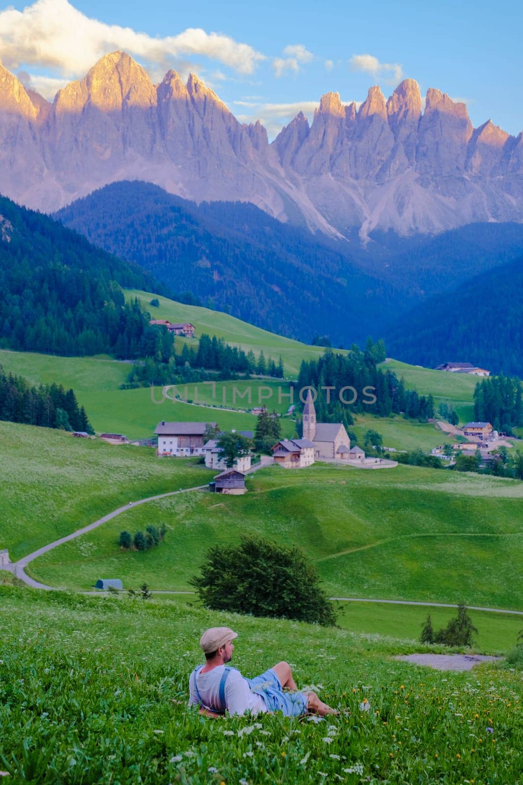 Men viewing the landscape of Santa Maddalena Village in Dolomites Italy, Santa Magdalena village magical Dolomites mountains, Val di Funes valley, Trentino Alto Adige region, South Tyrol, Italy,