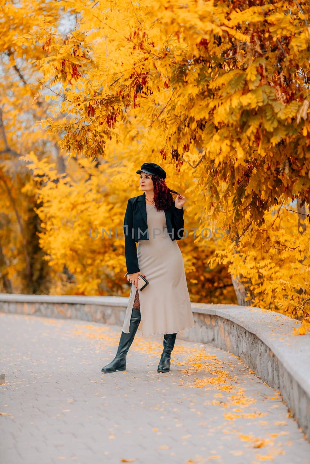 A woman walks outdoors in autumn, enjoys the autumn weather