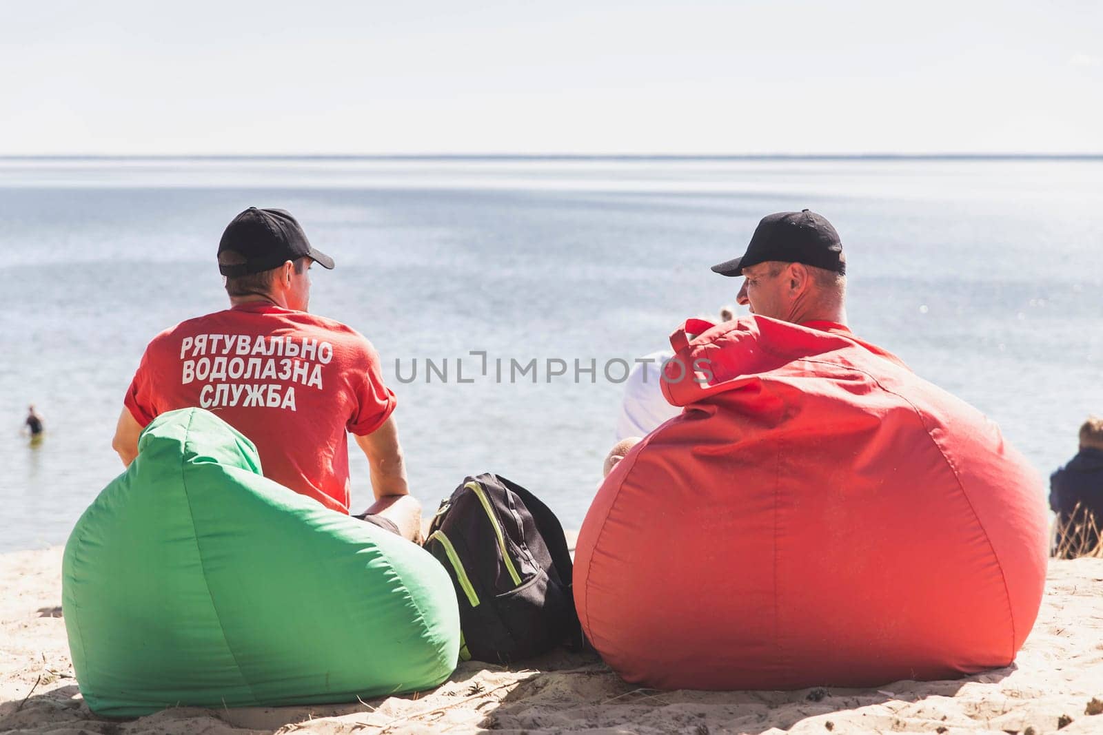 Glebovka, Ukraine, August 2020: Rescuers sit in soft chairs by the sea in Ukraine
