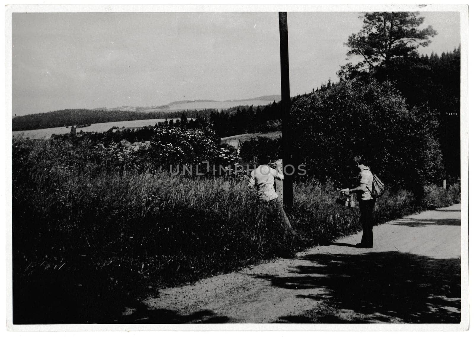 THE CZECHOSLOVAK SOCIALIST REPUBLIC - JUNE 9, 1981: Retro photo shows volunteers renovate a touristic sign. Black and white vintage photography