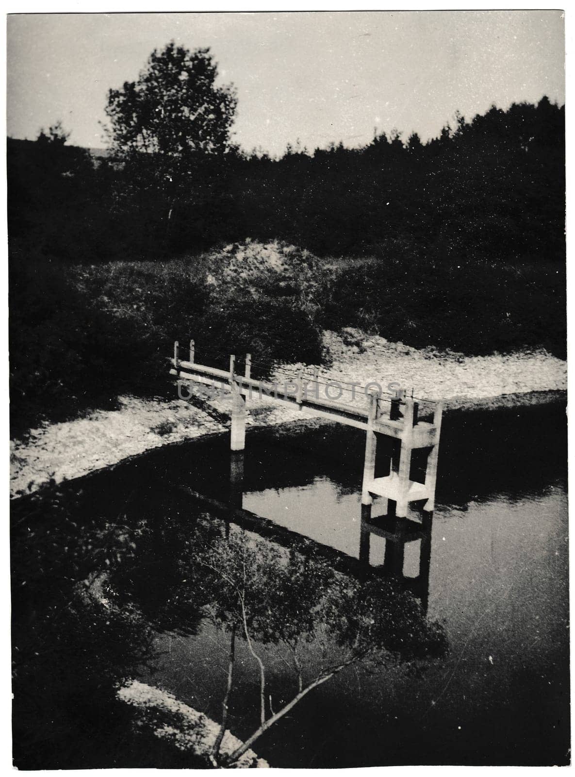 Retro photo shows sluice gate in the pond. Black and white vintage photography. by roman_nerud