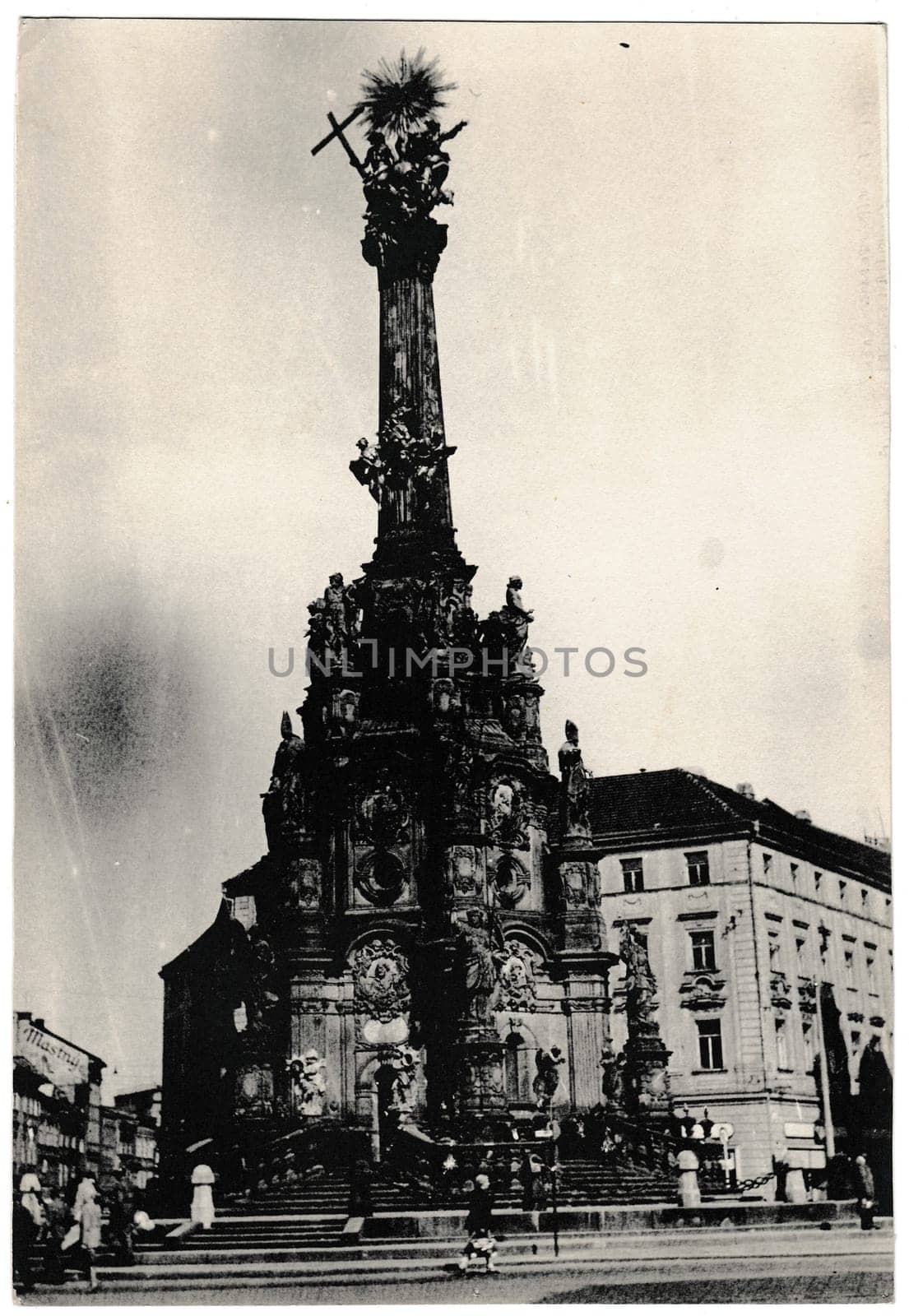 Retro photo shows The Holy Trinity Column - the largest group of Baroque statues within a single sculptural monument in Central Europe. Black and white vintage photography. by roman_nerud