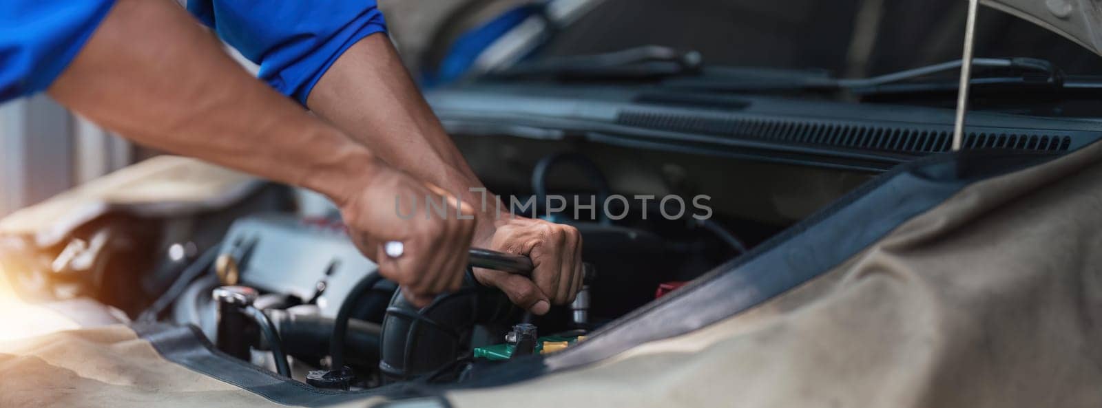Close up technician uses multimeter voltmeter to check voltage level in car battery. Service and Maintenance car battery. by nateemee