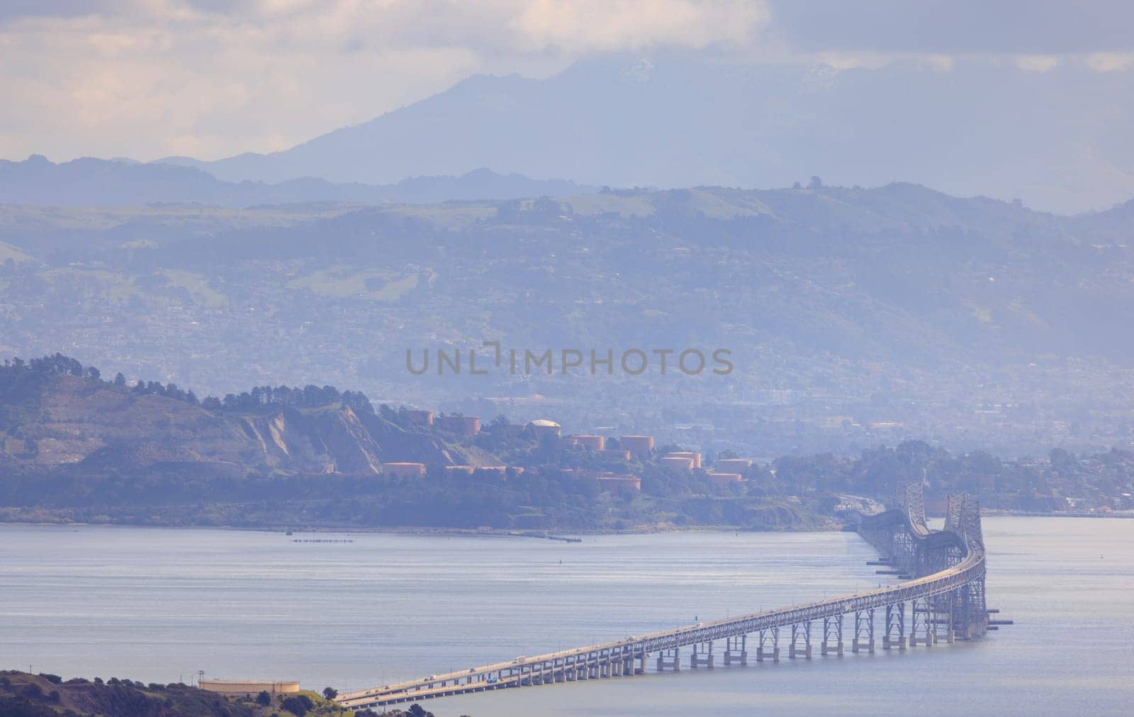 Richmond - San Rafael Bridge curves over San Francisco Bay on hazy day. High quality photo