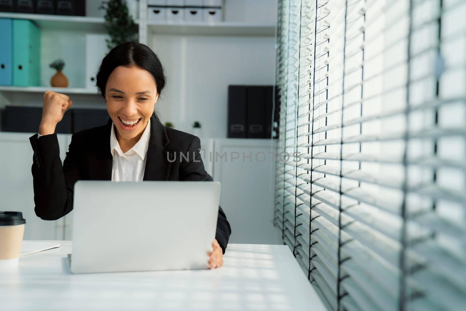 This photo depicts a young African American and competent woman at her workplace. A female employee in her office at work.