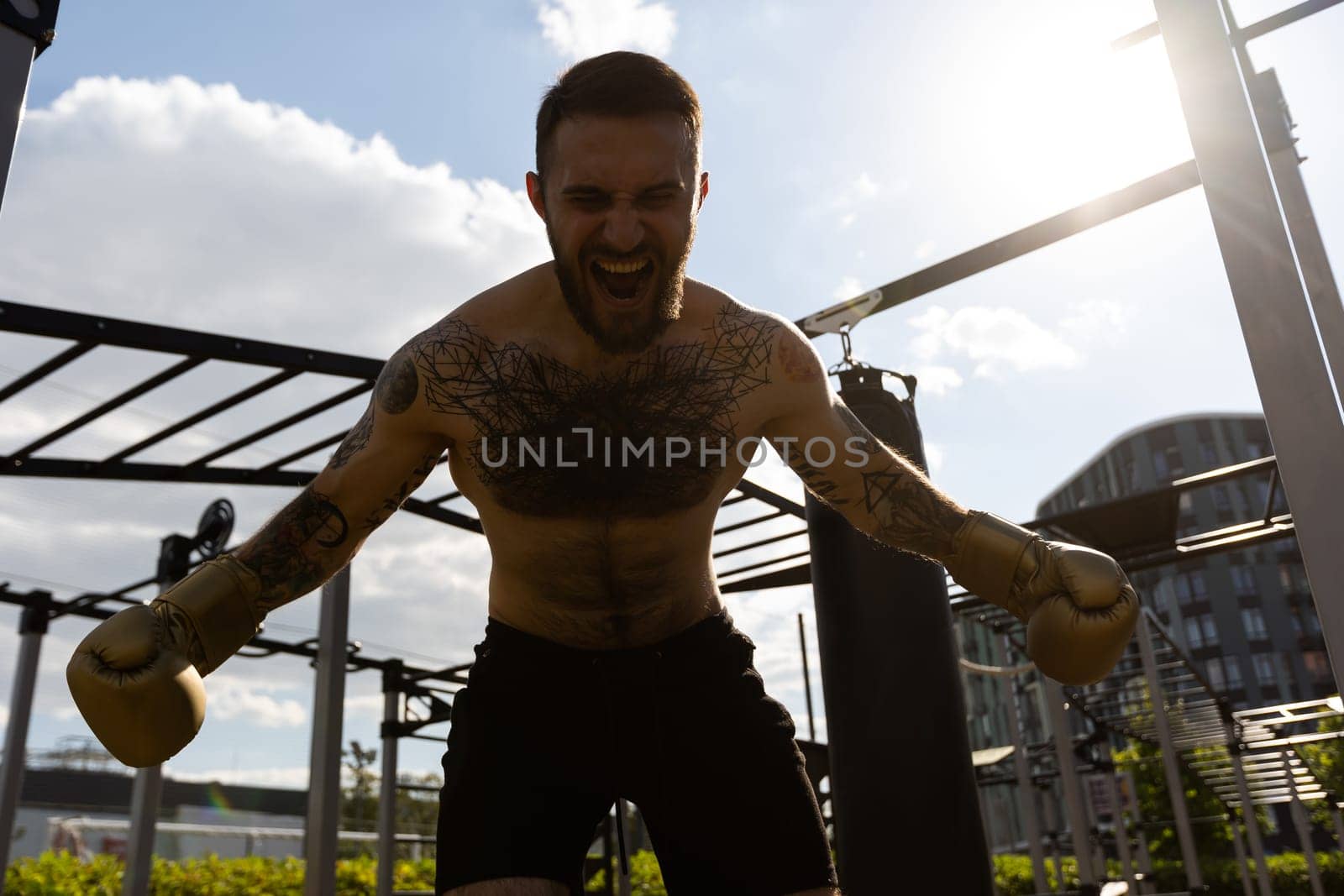 boxer athlete man putting on glove gloves prepared to train outdoors