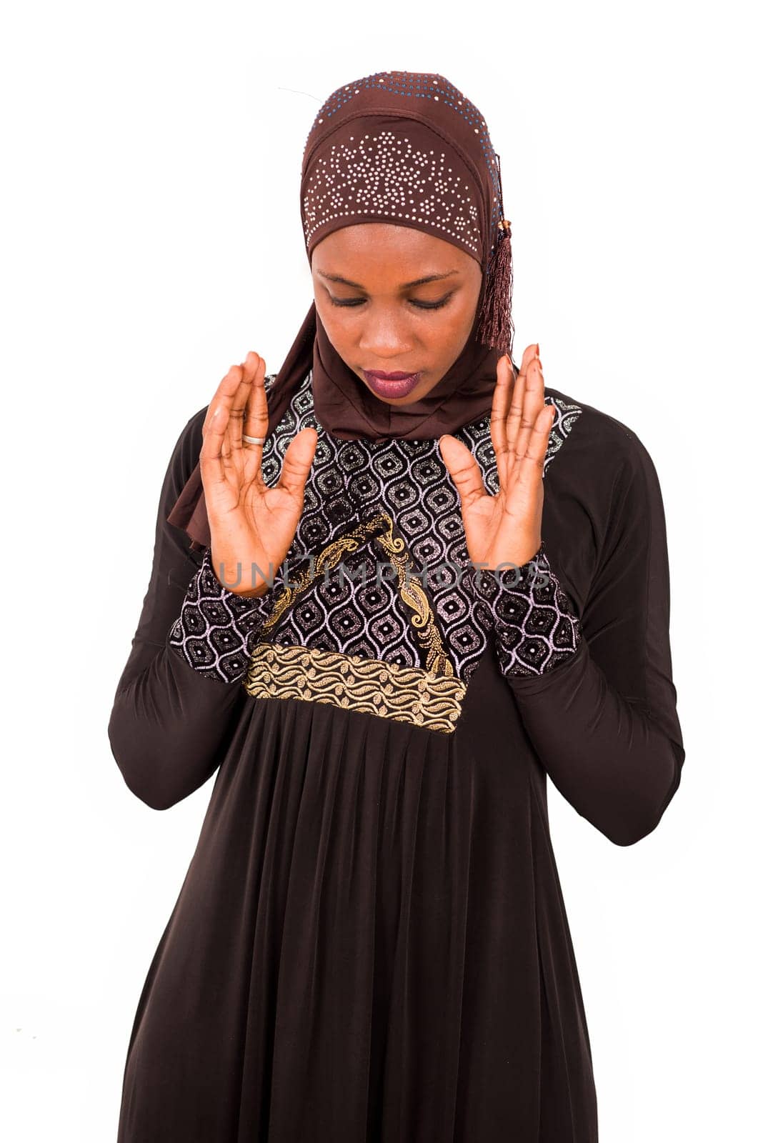 young muslim woman standing in dress isolated on white background praying.