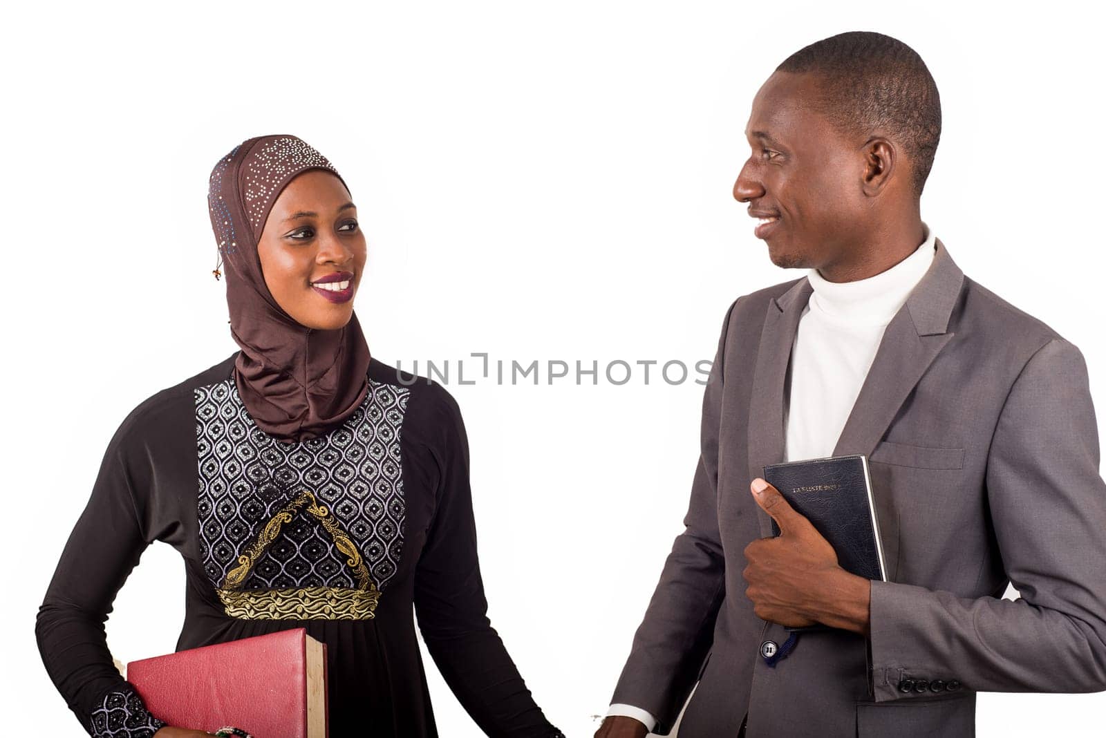 portraits of two religious people holding hands, smiling and holding religious documents.