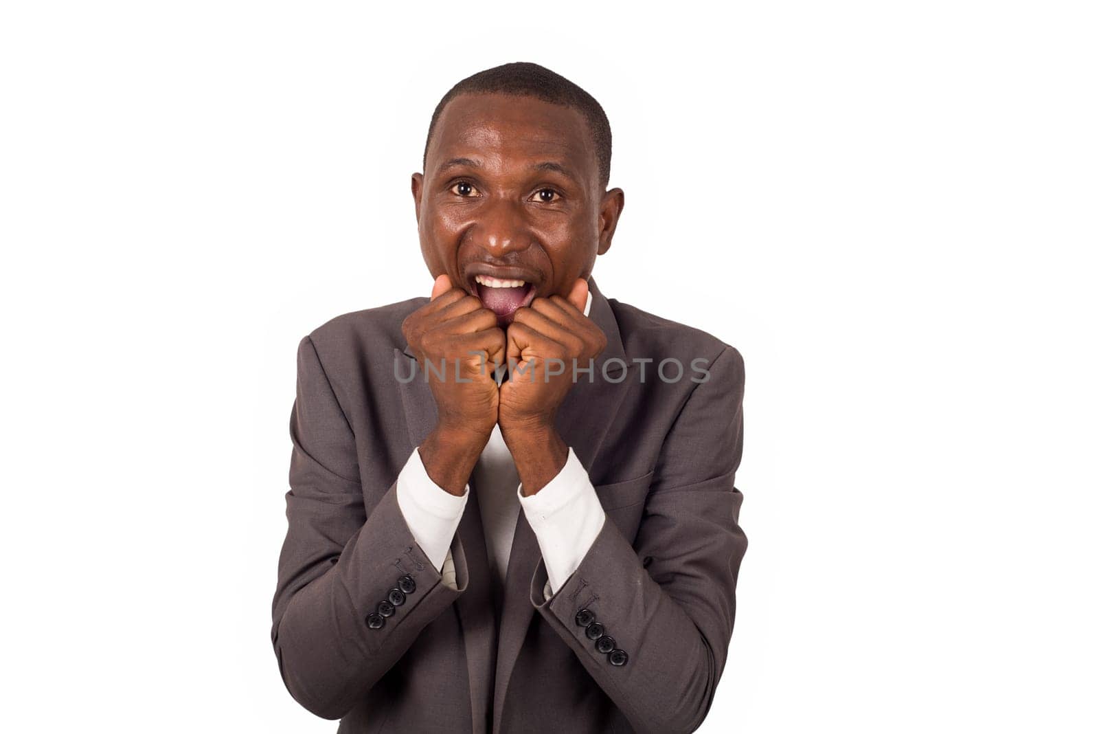 portrait of young man in suit standing and biting his fingers isolated on white background.