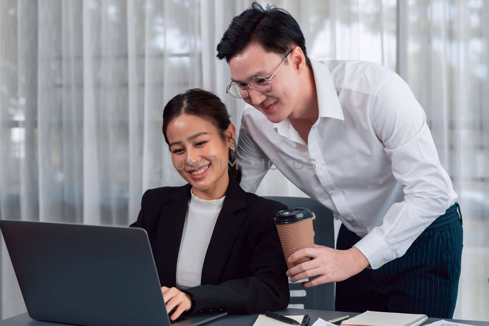 Mentor, manager with coffee advice younger colleagues in workplace. Couple businesspeople discussing financial strategy, working together for harmony and strong teamwork in office concept