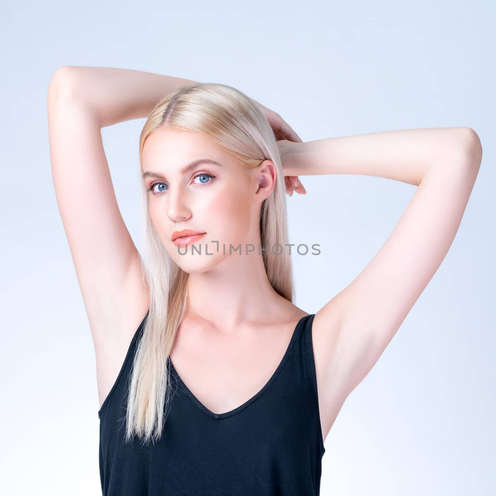 Personable woman lifting her armpit showing clean and hygiene underarm. by biancoblue