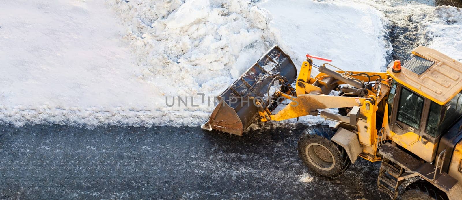 Cleaning and cleaning of roads in the city from snow in winter by AnatoliiFoto