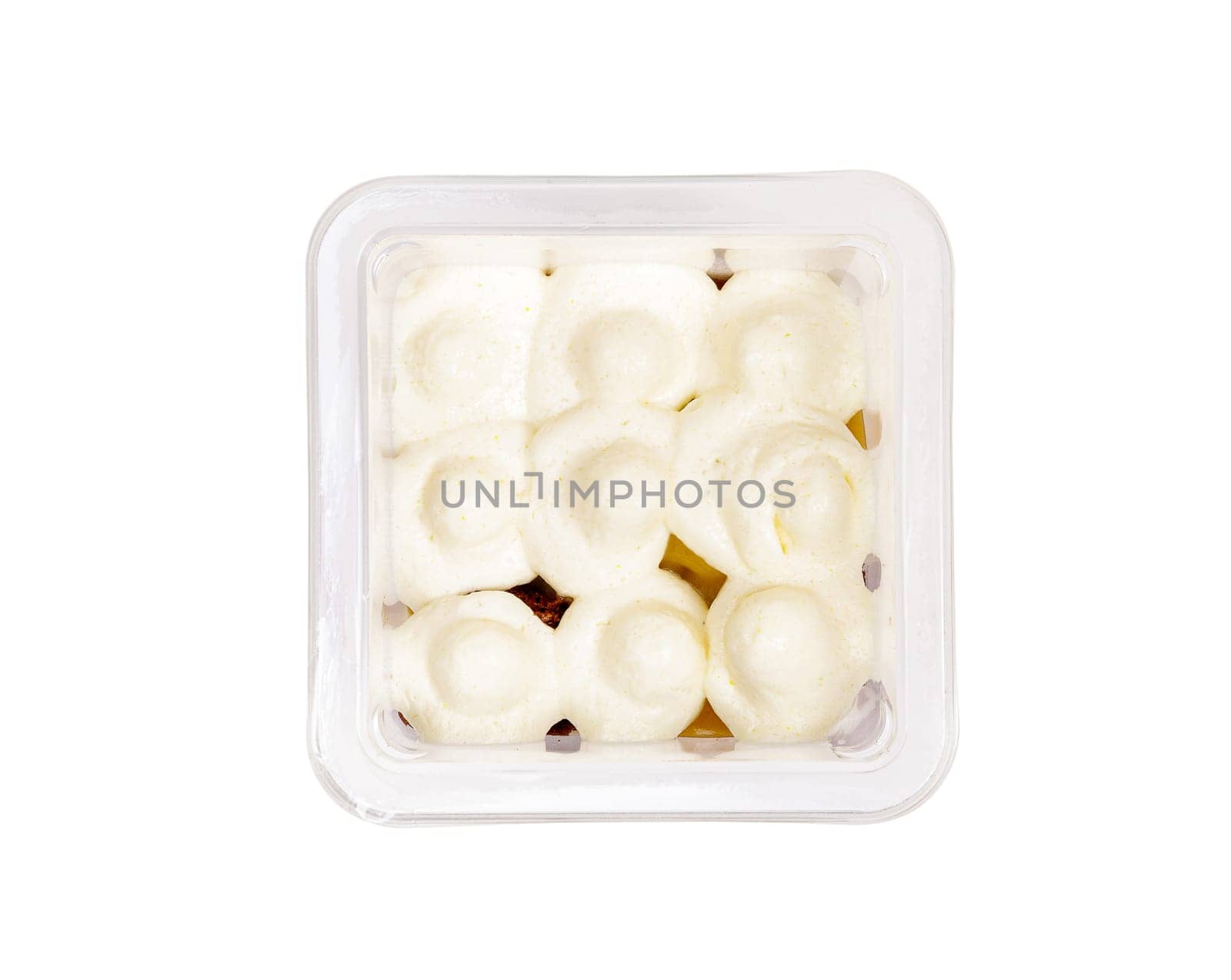 Portion of chocolate caramel mousse in a plastic cup on a white background. High quality photo. View from above.