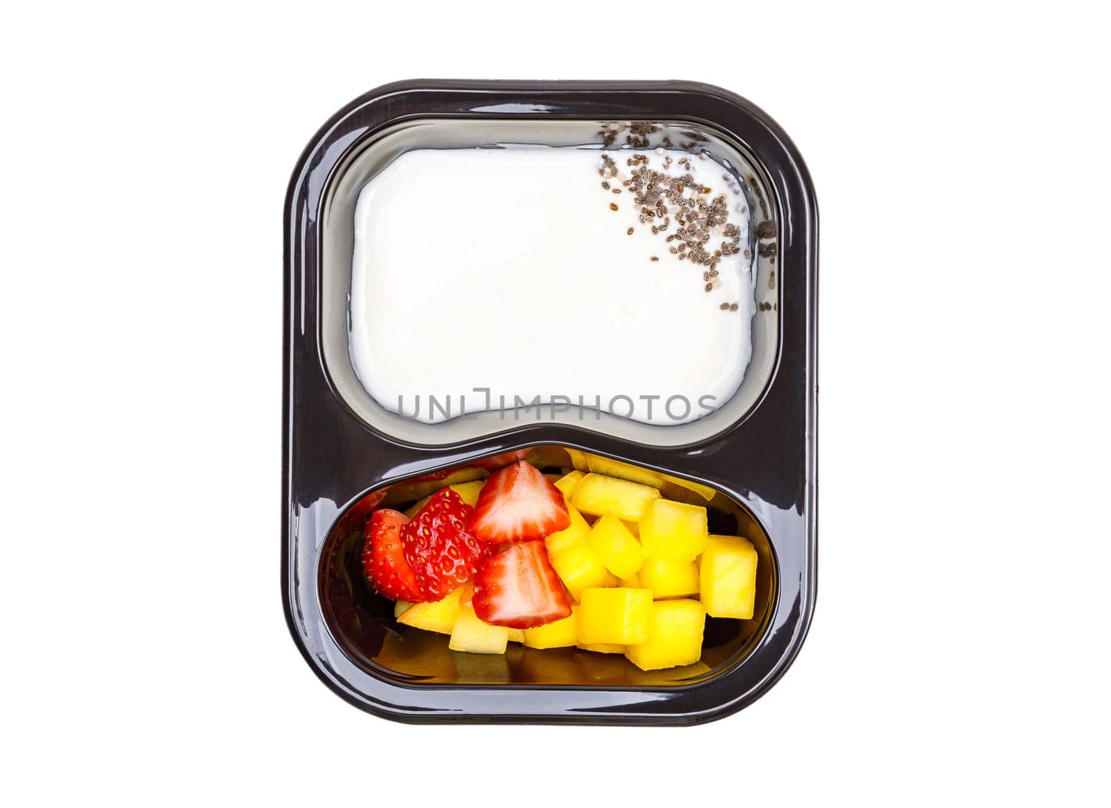 Portion of yogurt dessert with strawberry and mango in a plastic bowl. High quality photo. View from above.